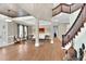 Elegant foyer with staircase, hardwood floors, and open floor plan flowing into living area at 3324 Thomas Rd, Raleigh, NC 27607
