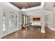Light-filled foyer with decorative door, hardwood floors, and seating area at 3324 Thomas Rd, Raleigh, NC 27607