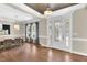 Dining area near entry and decorative glass front door, with window views and hardwood floors at 3324 Thomas Rd, Raleigh, NC 27607