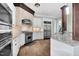 Updated kitchen showcasing stainless steel appliances, granite countertops, and stylish tile backsplash at 3324 Thomas Rd, Raleigh, NC 27607