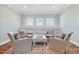 Inviting seating area with four comfortable armchairs, an ottoman, and built-in shelving at 3324 Thomas Rd, Raleigh, NC 27607