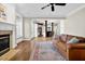 Spacious living room with hardwood floors, fireplace, and an open view to the kitchen at 3324 Thomas Rd, Raleigh, NC 27607