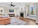 Cozy living room with a fireplace, built-in shelving, and a comfortable leather sofa at 3324 Thomas Rd, Raleigh, NC 27607
