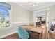Home office featuring a modern desk, hardwood floors, and views to living area at 3324 Thomas Rd, Raleigh, NC 27607