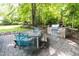 Landscaped backyard showcasing an outdoor kitchen, dining area, and mature trees, perfect for outdoor living at 3359 Hampton Rd, Raleigh, NC 27607