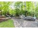Beautiful backyard oasis with a stone fireplace, outdoor seating, and an outdoor kitchen with a built-in grill at 3359 Hampton Rd, Raleigh, NC 27607