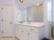 Bright bathroom featuring a white vanity with a white countertop and a large mirror at 3359 Hampton Rd, Raleigh, NC 27607