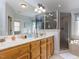 Spacious bathroom with double vanities, a large mirror, and a glass-enclosed shower at 3359 Hampton Rd, Raleigh, NC 27607