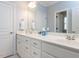 Bright bathroom featuring double sinks with white cabinetry, a large mirror, and clean, modern finishes at 3359 Hampton Rd, Raleigh, NC 27607