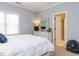 Serene bedroom with a window, a white dresser, and a comfortable bed, perfect for relaxation at 3359 Hampton Rd, Raleigh, NC 27607