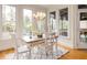 Bright dining room with large windows, wood flooring, and a stylish chandelier at 3359 Hampton Rd, Raleigh, NC 27607