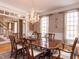 Spacious dining room with hardwood floors, chandelier, and large dining table at 3359 Hampton Rd, Raleigh, NC 27607