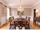 Elegant dining room with a large table, chandelier, and hardwood floors at 3359 Hampton Rd, Raleigh, NC 27607