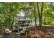 Expansive backyard featuring an outdoor kitchen, outdoor seating area, covered deck, and lush landscaping at 3359 Hampton Rd, Raleigh, NC 27607