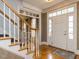Bright foyer featuring hardwood floors and staircase with white railings at 3359 Hampton Rd, Raleigh, NC 27607