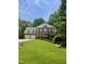 Lovely brick home with a well-maintained lawn, mature trees, and a welcoming entrance at 3359 Hampton Rd, Raleigh, NC 27607
