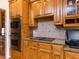 Well-equipped kitchen featuring wooden cabinets, granite counters, and stainless steel appliances at 3359 Hampton Rd, Raleigh, NC 27607