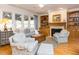 Comfortable living room with large windows, fireplace, hardwood floors, and built-in bookcases at 3359 Hampton Rd, Raleigh, NC 27607