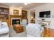 Cozy living room with hardwood floors, fireplace, built-in shelving, and comfortable seating arrangements at 3359 Hampton Rd, Raleigh, NC 27607