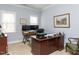 Well-lit home office with ample desk space and natural light from two large windows at 3359 Hampton Rd, Raleigh, NC 27607