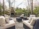 Outdoor space with a stone fireplace, patio, and cushioned wicker seating is ideal for gathering and relaxation at 3359 Hampton Rd, Raleigh, NC 27607