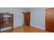 View of bedroom with hardwood floors, gray walls, and antique cabinet at 4166 Nc 119, Mebane, NC 27302