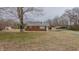 Quaint red brick home with a large front yard and mature trees offering shade at 4166 Nc 119, Mebane, NC 27302
