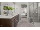 Modern bathroom features dual sinks, tile flooring and glass-enclosed shower at 521 Providence Springs Ln, Fuquay Varina, NC 27526