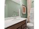 Charming bathroom featuring a modern vanity, a well-lit mirror, and a shower with a decorative curtain at 521 Providence Springs Ln, Fuquay Varina, NC 27526
