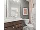 Modern bathroom with a sleek vanity, a well-lit mirror, and a shower with stylish fixtures, creating a fresh and clean space at 521 Providence Springs Ln, Fuquay Varina, NC 27526