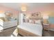 Bright and cheerful bedroom with colorful decor, featuring a stylish chandelier, a cozy bed, and complementary furnishings at 521 Providence Springs Ln, Fuquay Varina, NC 27526