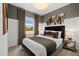 Relaxing bedroom showcasing a comfortable bed with stylish bedding, complemented by natural light and elegant decor at 521 Providence Springs Ln, Fuquay Varina, NC 27526