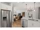 Open-concept kitchen with stainless steel appliances flows into a spacious living area at 521 Providence Springs Ln, Fuquay Varina, NC 27526