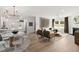 Bright open concept showcasing a modern living room connected to dining area and kitchen at 521 Providence Springs Ln, Fuquay Varina, NC 27526