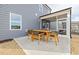 Charming outdoor patio with a dining table and seating, adjacent to a screened porch, perfect for entertaining and relaxation at 521 Providence Springs Ln, Fuquay Varina, NC 27526