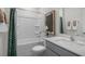 Well-lit bathroom with a combination tub and shower, white fixtures, and tasteful decor at 607 Dorset Stream Dr, Fuquay Varina, NC 27526
