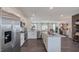 Modern kitchen with stainless steel refrigerator open to living room at 609 Dorset Stream Dr, Fuquay Varina, NC 27526