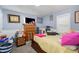 Cozy bedroom with blue walls, a wooden dresser, and natural light from the window at 628 East Ave, Henderson, NC 27536