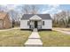 Charming home featuring a covered porch, gray siding, and a well-maintained front yard at 628 East Ave, Henderson, NC 27536