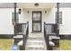 Home entrance with wrought iron door, black railings, and well-lit porch at 628 East Ave, Henderson, NC 27536