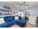 Inviting living room with a plush blue sofa, stylish decor, and natural light at 628 East Ave, Henderson, NC 27536
