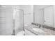 Bright bathroom features a granite countertop, framed mirror, and a glass-enclosed shower at 631 Contento Ct, Sanford, NC 27330