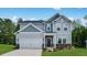 Charming two-story home with a two-car garage, well manicured lawn and a beautifully designed facade at 631 Contento Ct, Sanford, NC 27330