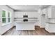 Modern kitchen with white cabinets, stainless steel appliances, granite countertops, and a kitchen island at 631 Contento Ct, Sanford, NC 27330