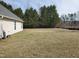 Large backyard featuring an open grassy area, perfect for outdoor activities and relaxation at 631 Natalie Dr, Graham, NC 27253