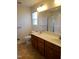 This bathroom features a double vanity with a large mirror and a glass enclosed shower at 631 Natalie Dr, Graham, NC 27253