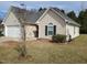 Attractive home exterior showing the attached garage and inviting front yard with simple landscaping at 631 Natalie Dr, Graham, NC 27253
