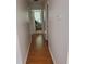 Hallway view showcasing the home's layout, leading to a bedroom with a glimpse of natural light at 631 Natalie Dr, Graham, NC 27253