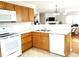 Spacious kitchen showing stainless steel sink, white countertops and appliances, wooden cabinets at 631 Natalie Dr, Graham, NC 27253