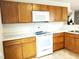 Well-lit kitchen features white countertops, a range of appliances and wooden cabinets at 631 Natalie Dr, Graham, NC 27253